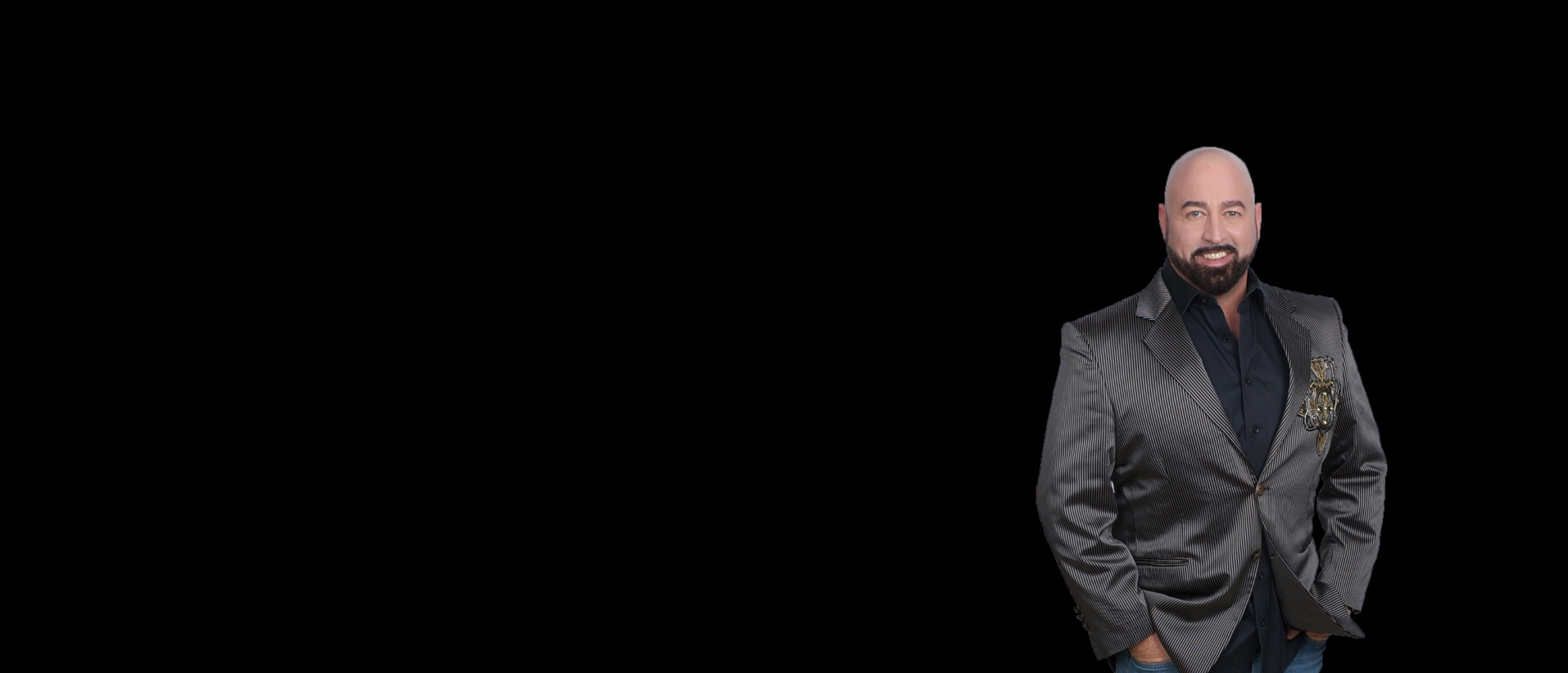 Justin James in a pinstripe blazer against a black background