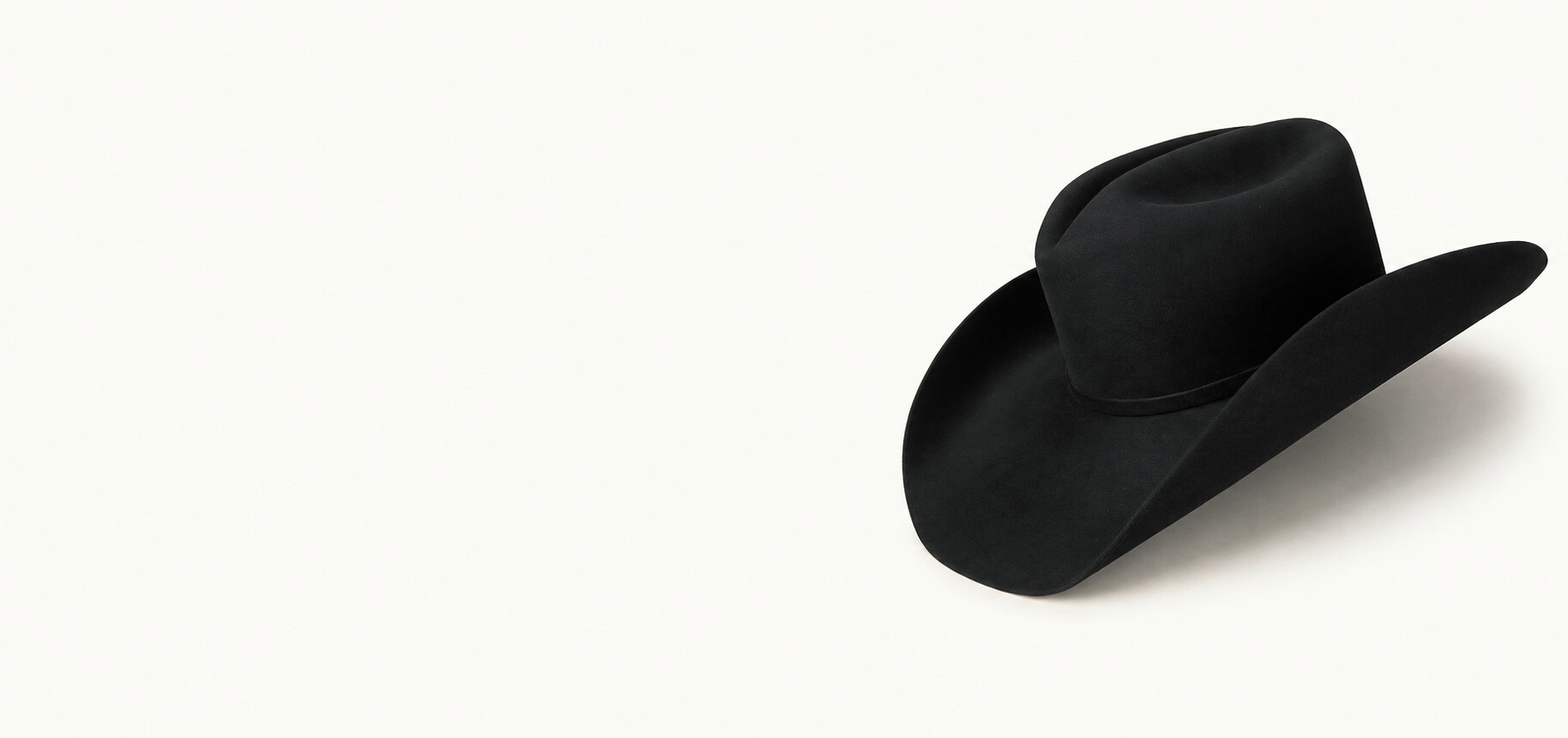 Justin James' black cowboy hat on a cream background