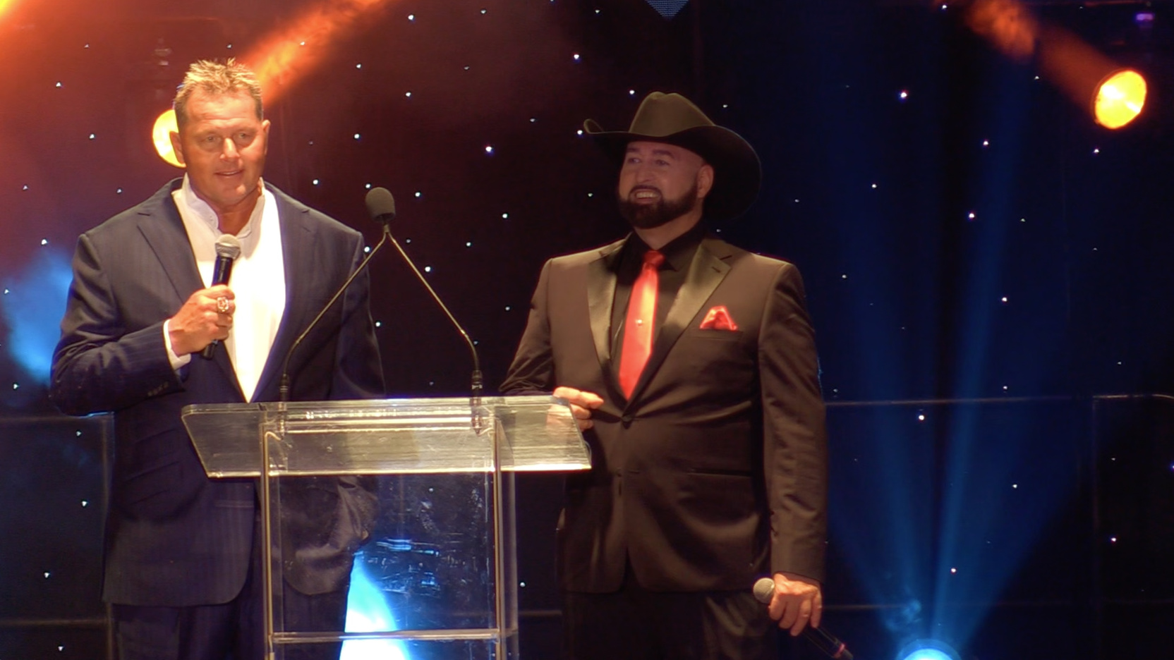 Justin James on stage with Roger Clemens during a live benefit auction